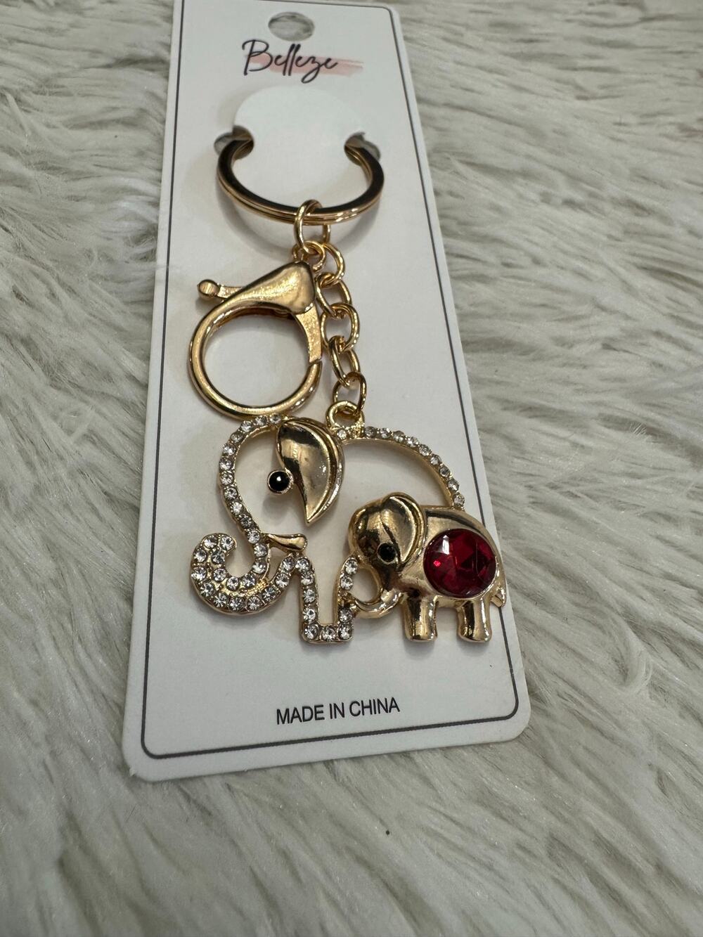 Gold tone elephant mom and baby keychain with rhinestones and red gemstone